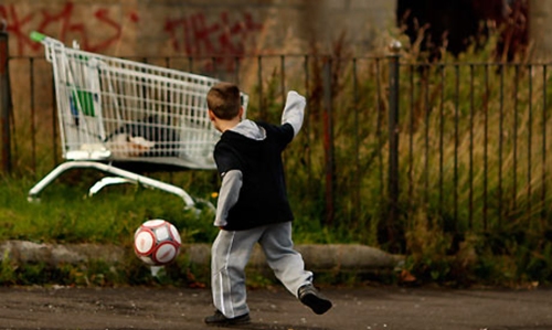Child playing on council estate
